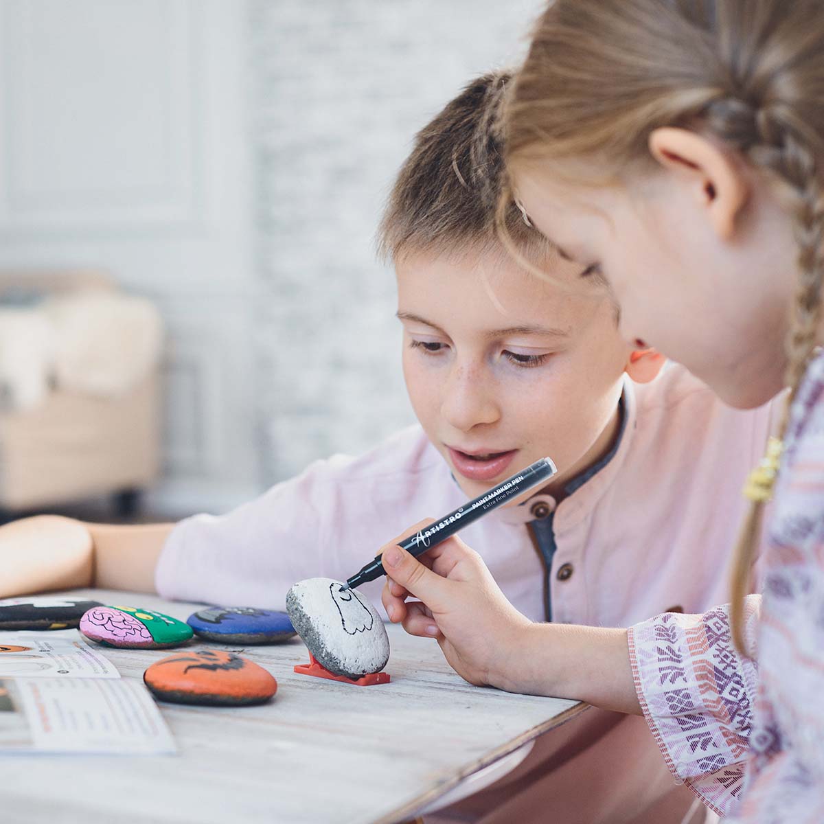 kids drawing on rocks